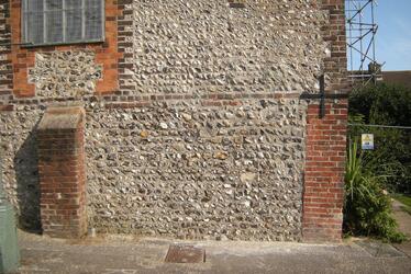 Photograph showing flintwork after renovation works began. Photograph showing flintwork after renovation works began.