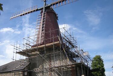 Photograph showing Blatchington Windmill enshrouded in scaffold during restoration works Photograph showing Blatchington Windmill enshrouded in scaffold during restoration works